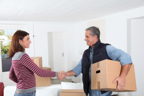 Packed boxes and wrapped household items ready for flat removals in Shadwell